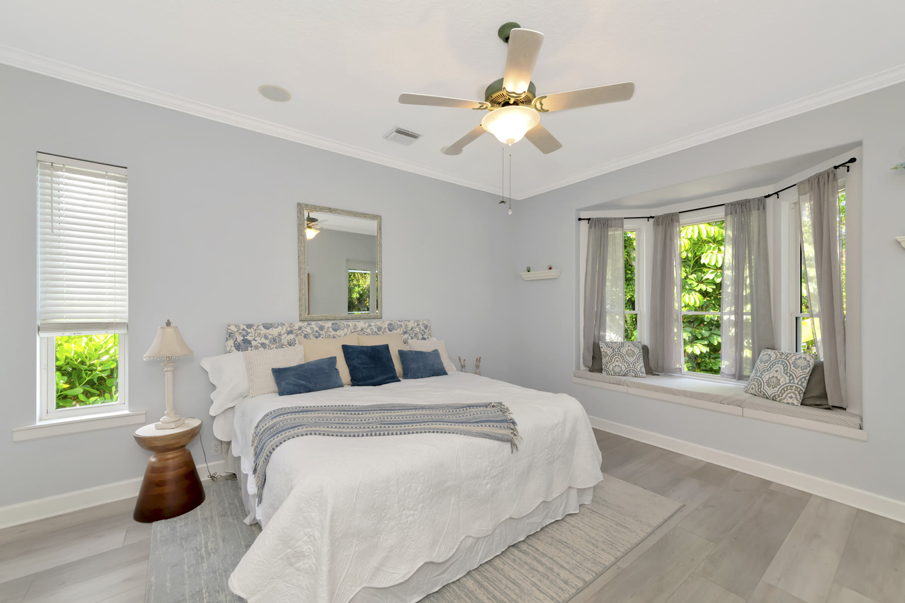 Bedroom staged with a floral headboard and blue accents